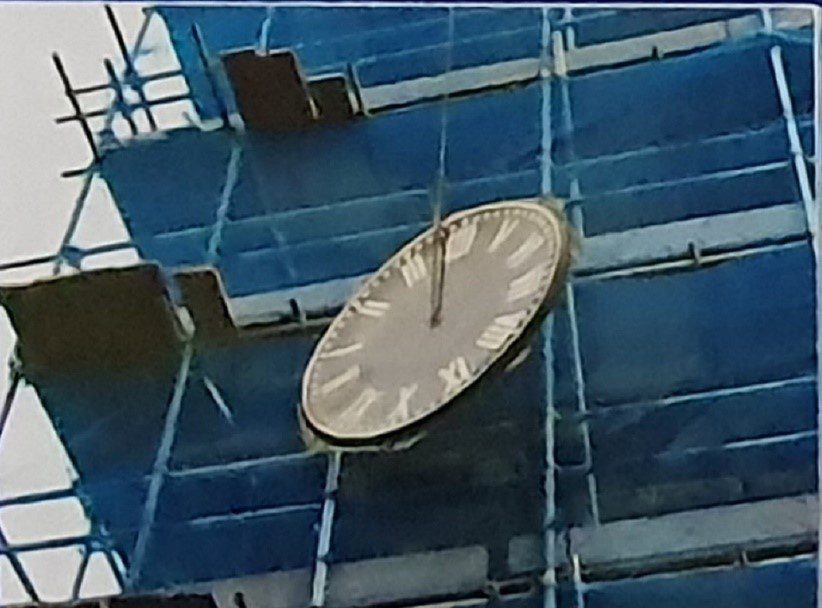 Clock face being lowered to the ground