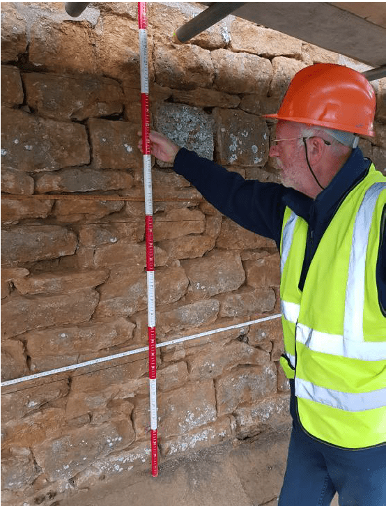 Person surveying stonework