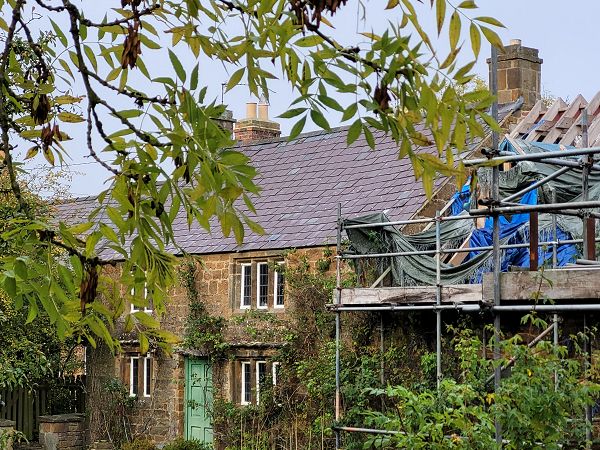 Large house with scaffolding on the right