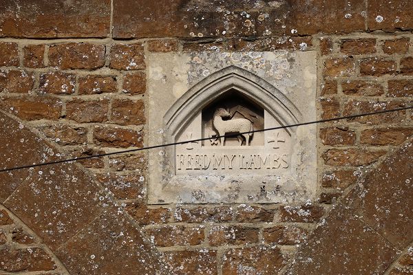 Small statue in a niche on the side of building