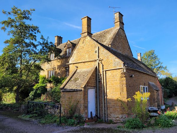 Large farmhouse with outbuilding at forefront