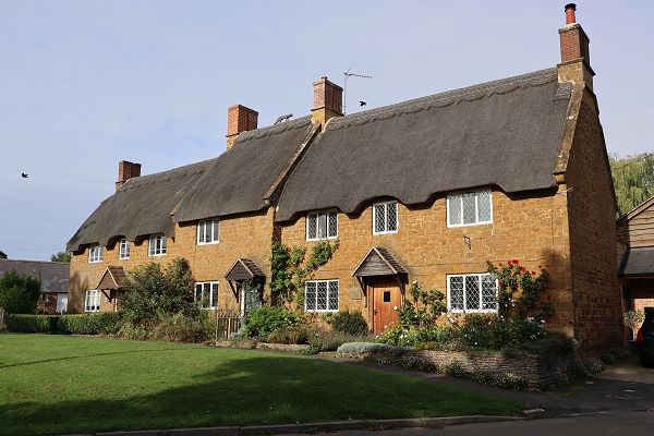 Three adjoining thatched houses