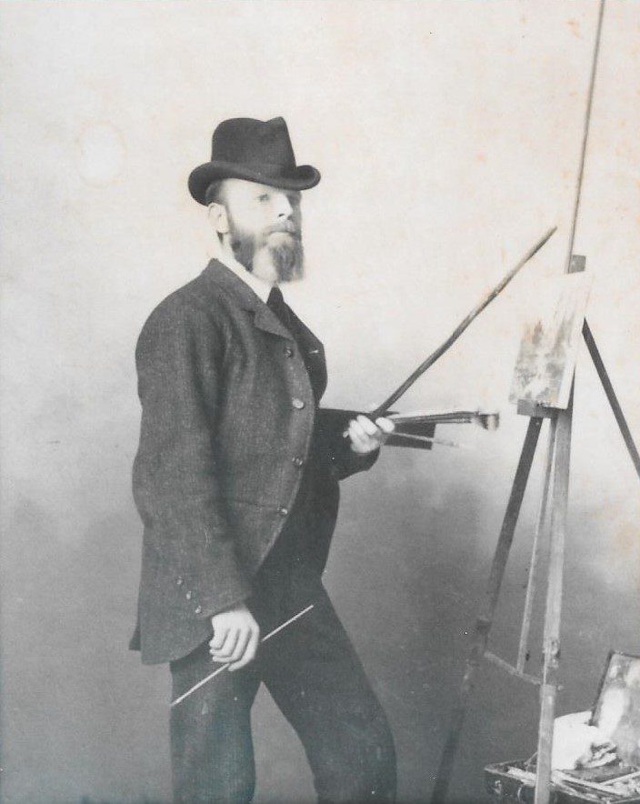 Person painting a picture on an easel