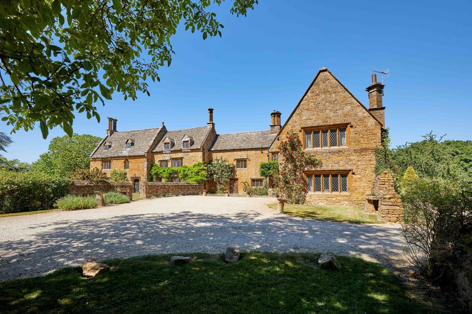 Large stone manor-house showing front courtyard