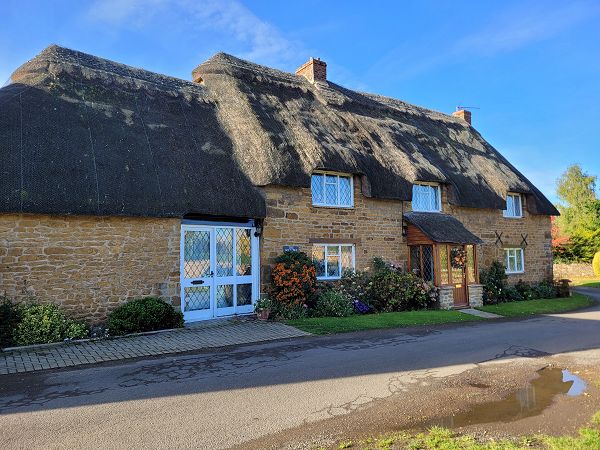 Thatched cottage with extension to the left