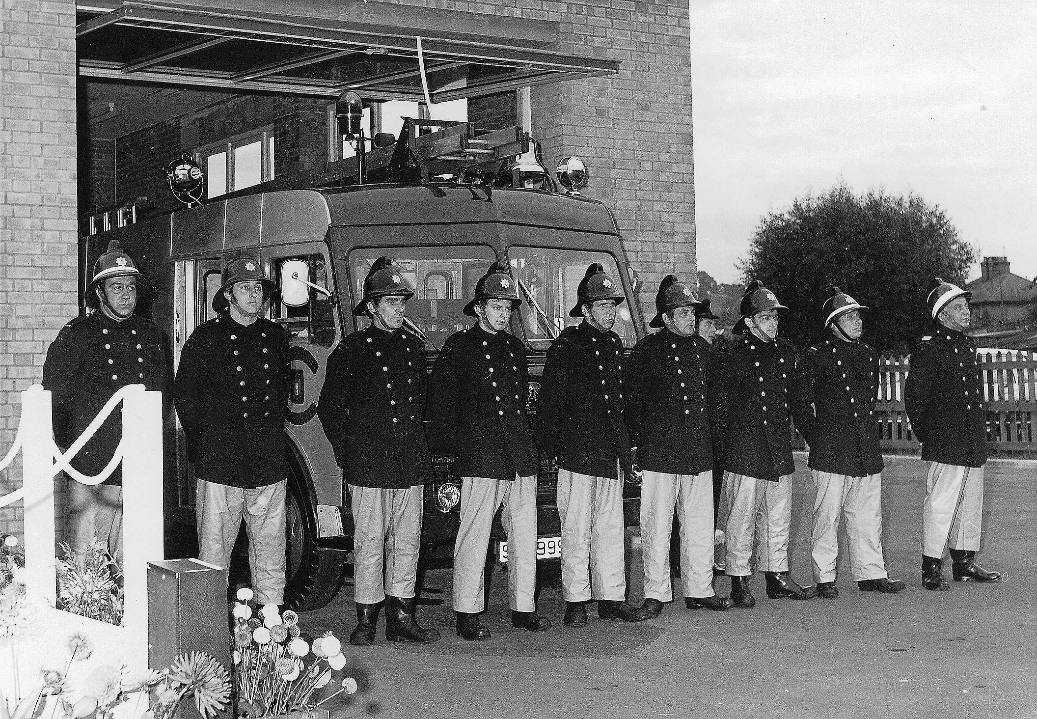 Firemen parading in front of fire engine