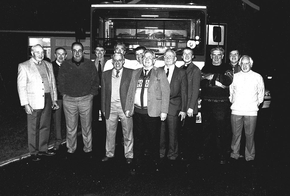 People in front of a fire engine