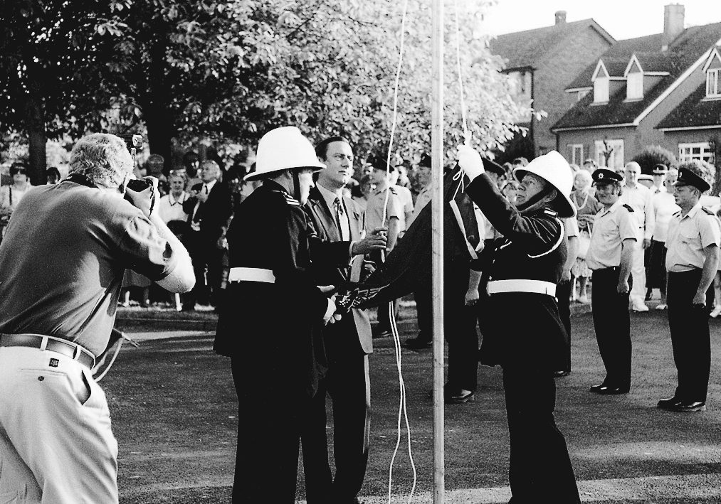Firemen lowering a flag