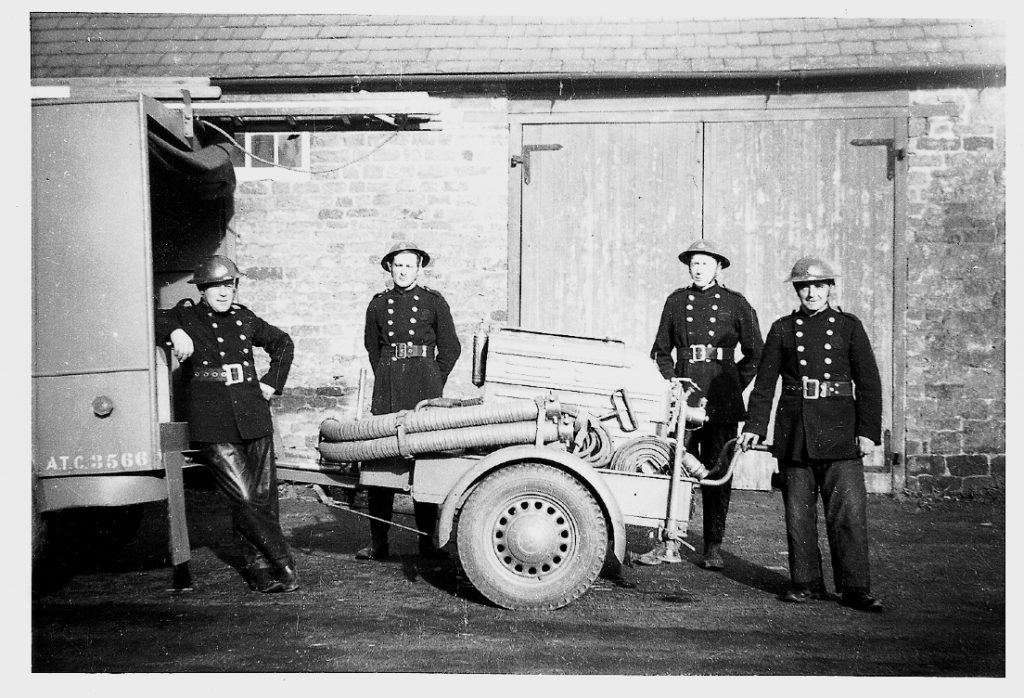 Group of firemen with a trailer