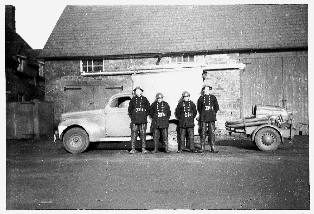 Group of firemen with a vehicle and trailer