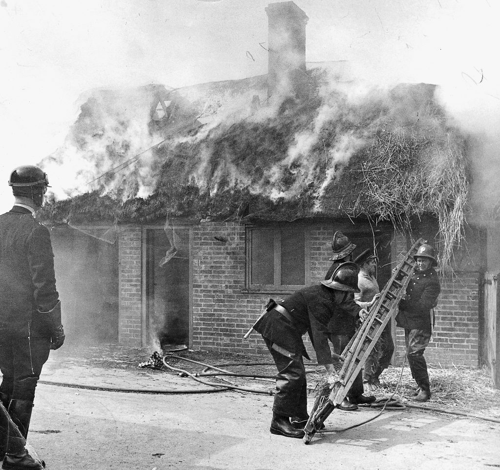 Firemen attending an outbuilding fire