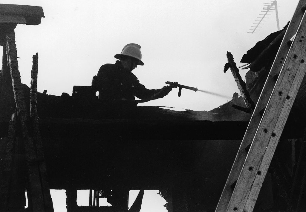 Fireman attending to a roof fire