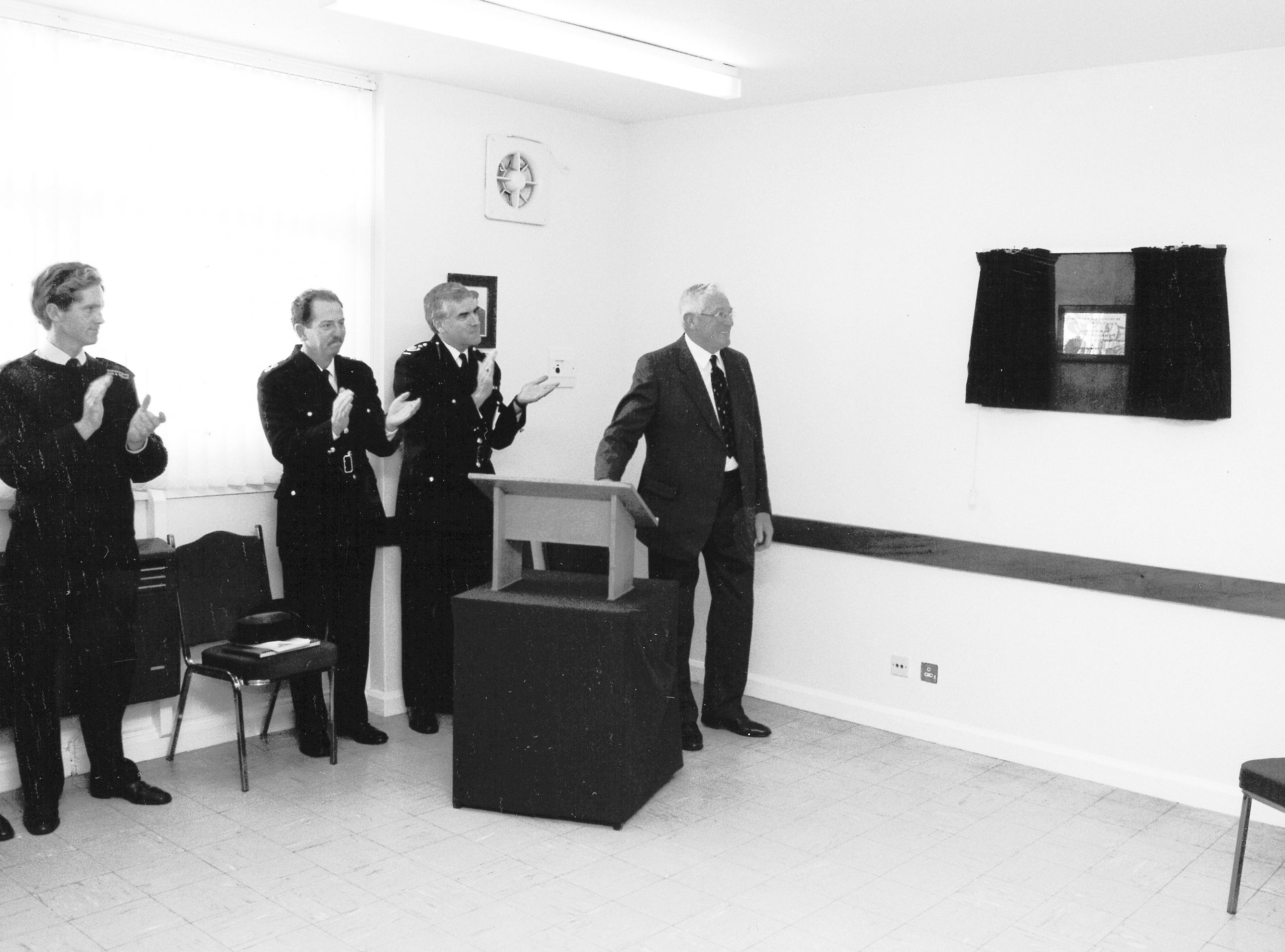 People watching plaque unveiling