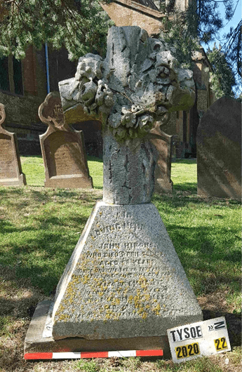 Memorial with a complicated sculpture of a tree stump on top