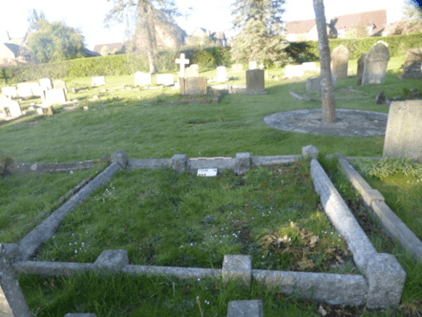 Large kerbed grave plot with other graves behind