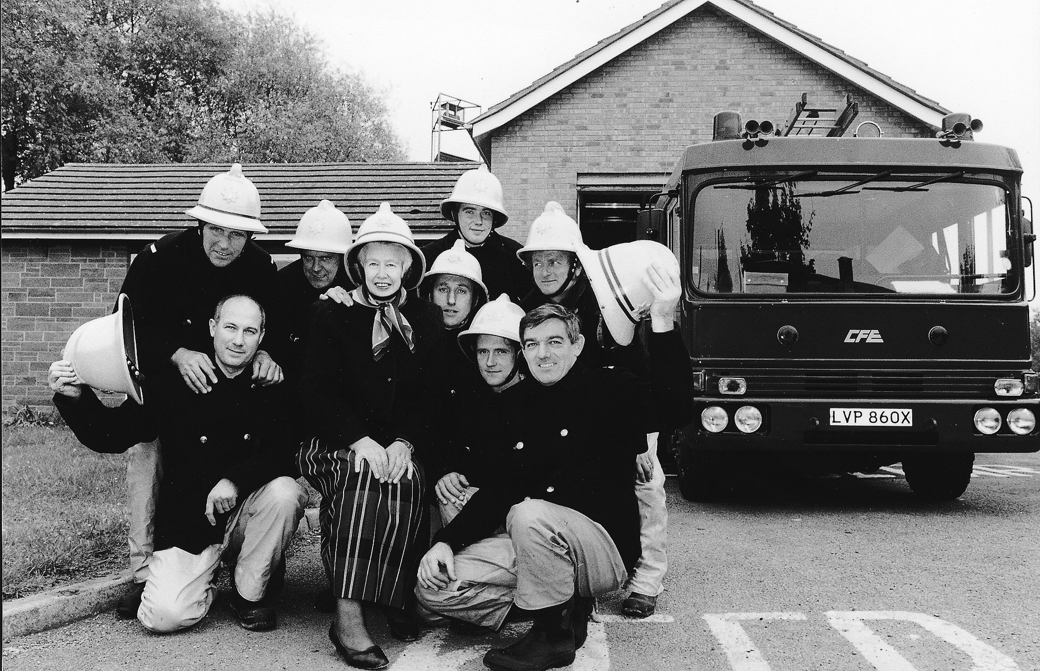 Group of people alongside a fire engine