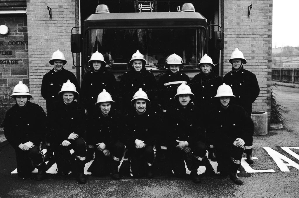 Firemen in front of fire station