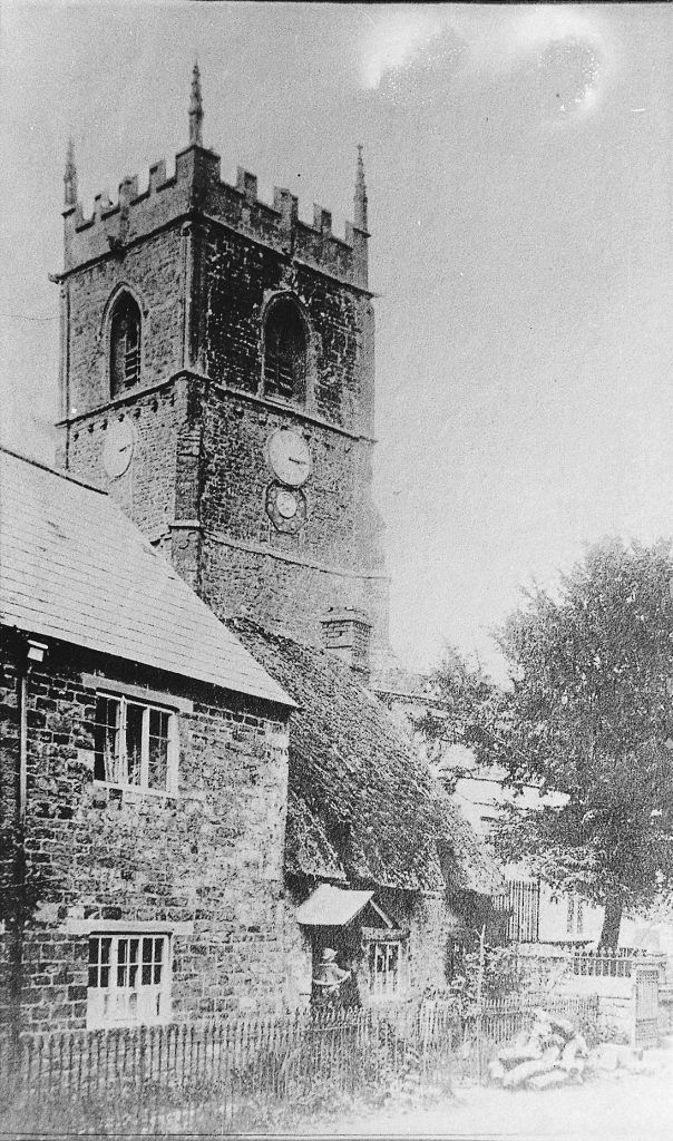 Church tower with cottage in foreground