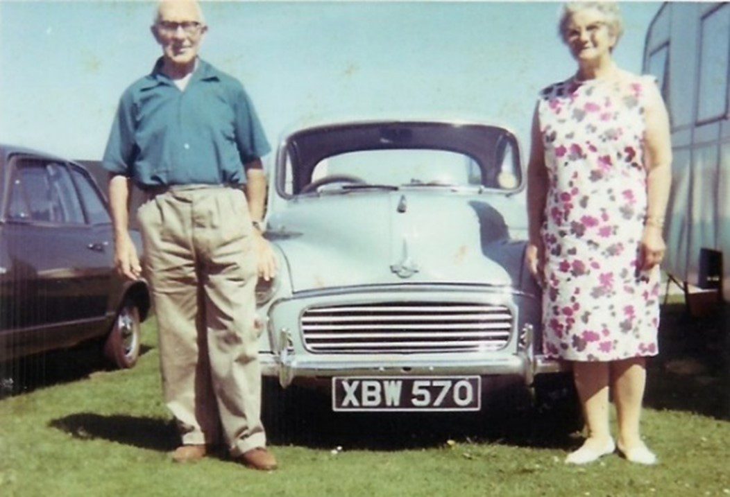 Couple standing in front of a car