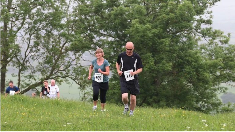 Windmill Run runners reach the top of the hill